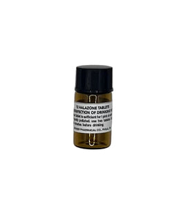 Small brown bottle with a black cap on a light gray background