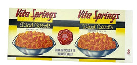 A vintage-style Vita Springs Diced Carrots box front shown flat against a white background. The packaging features two bowls of orange-red diced carrots, red script branding, black horizontal bands, and yellow sections.