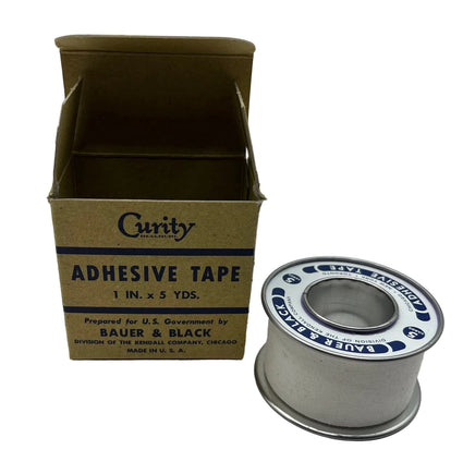 Vintage Curty adhesive tape spool next to its original cardboard box, featuring blue text on a brown box and white tape with blue lettering.