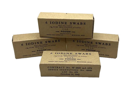 Four vintage brown cardboard boxes for '6 Iodine Swabs' stacked on a white surface against a light gray background. The boxes feature black printed text including 'POISON' and manufacturer details for Handmade Drug Supply Co.
